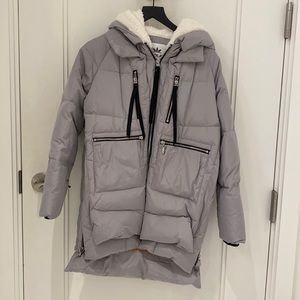 Orolay grey puffer coat with zipper details.